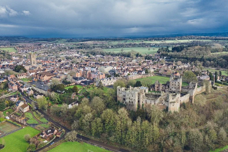 Aerial View Of Ludlow Castle And The Surrounding Town And Countryside